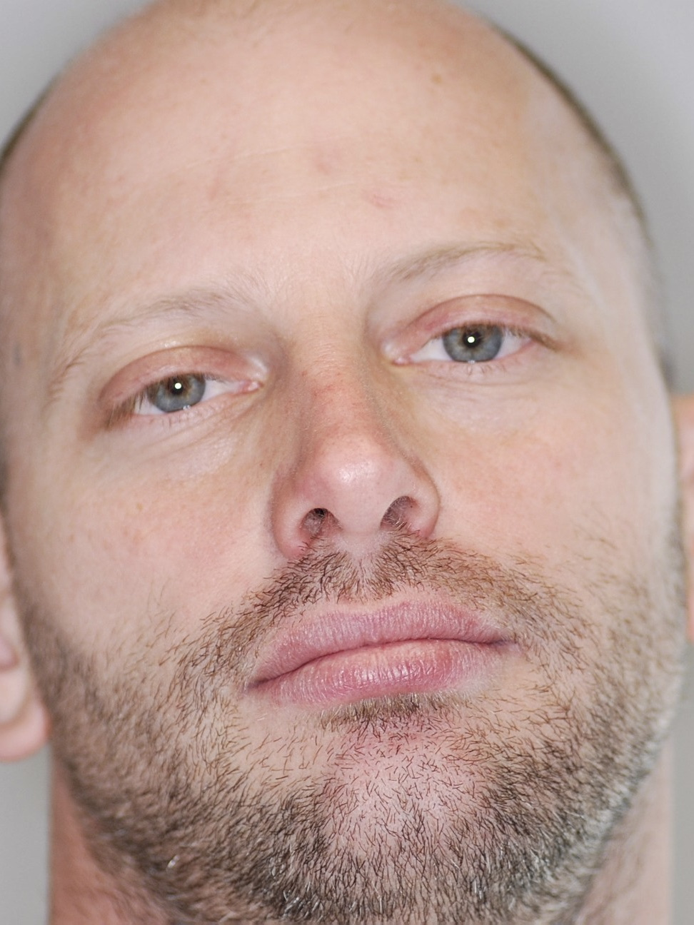 Close-up of a man with a neutral expression